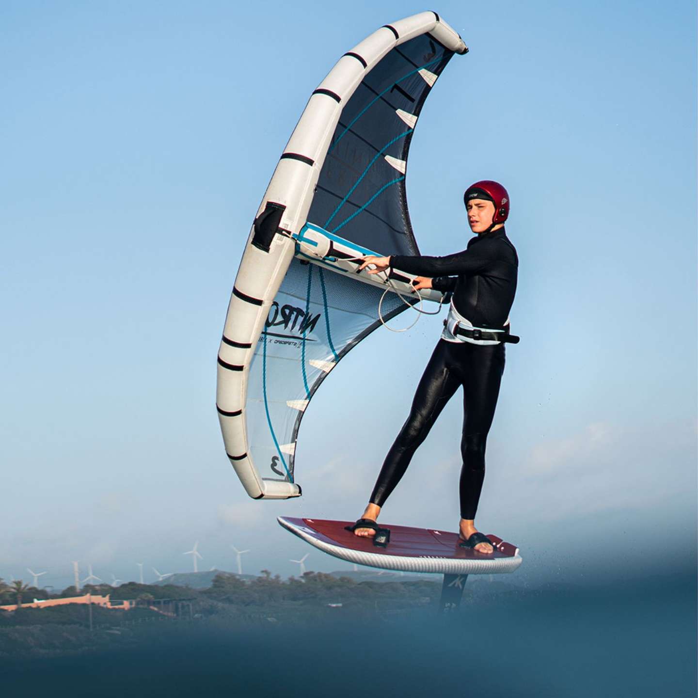 AK Compact v2 Wing Foil Board 2023 deck view showing the EVA traction pad, stance area, rails and nose shape