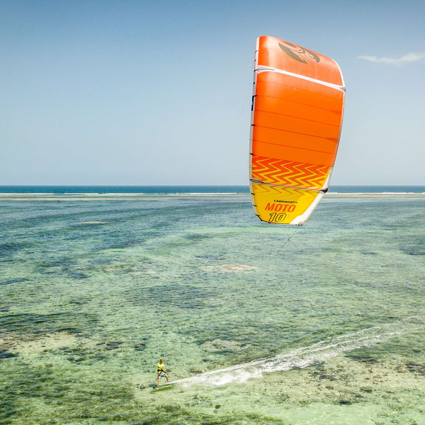 Cabrinha Moto 2021 Kite action image with the kite flying above the water, showing canopy shape, stability and on-water kitesurf performance