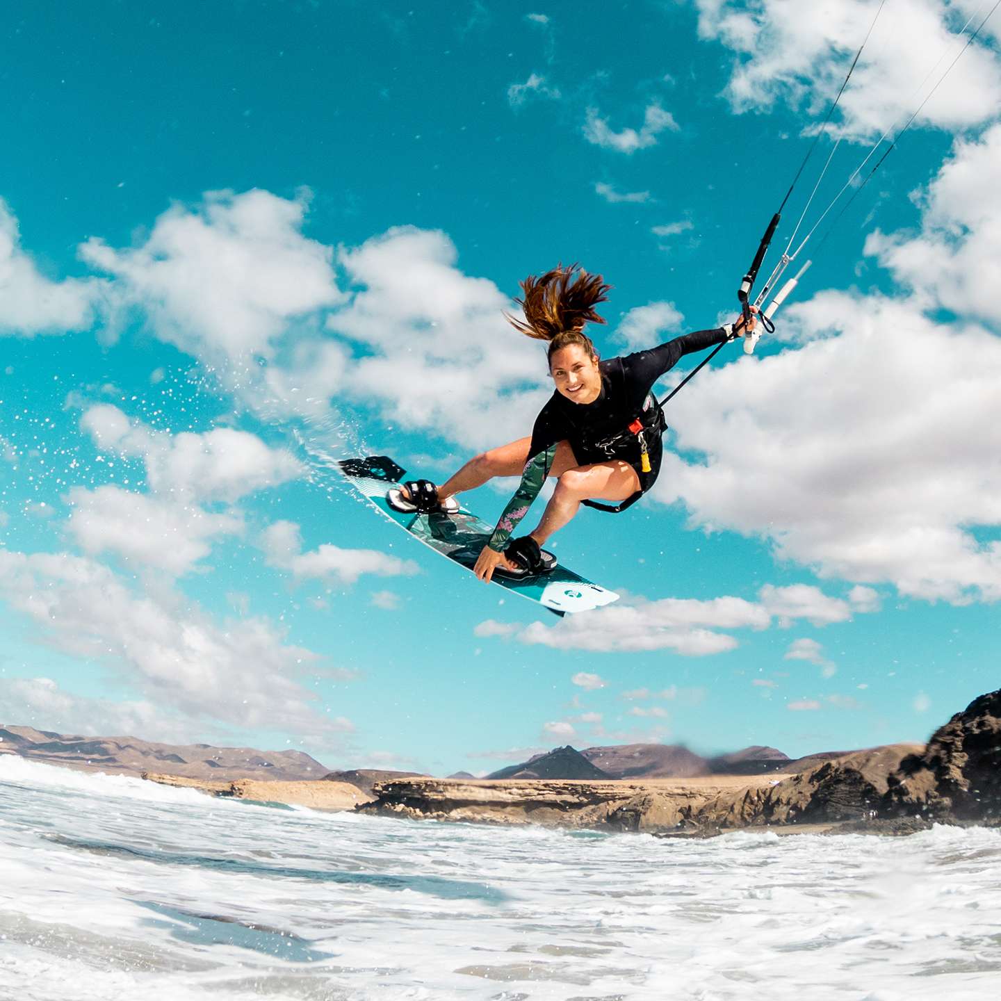 Cabrinha XCaliber Wood 2021 Kiteboard profile view showing the inflated kite arc, swept wingtips, strut depth and aerodynamic canopy shape