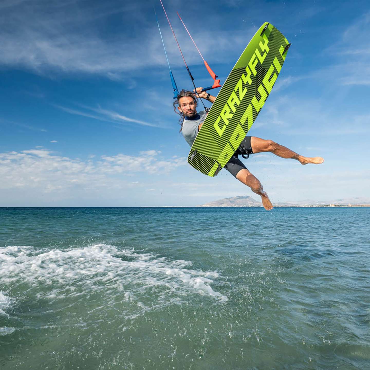 Crazyfly Raptor Ltd Neon 2025 Kiteboard deck view highlighting the top graphics and stance area