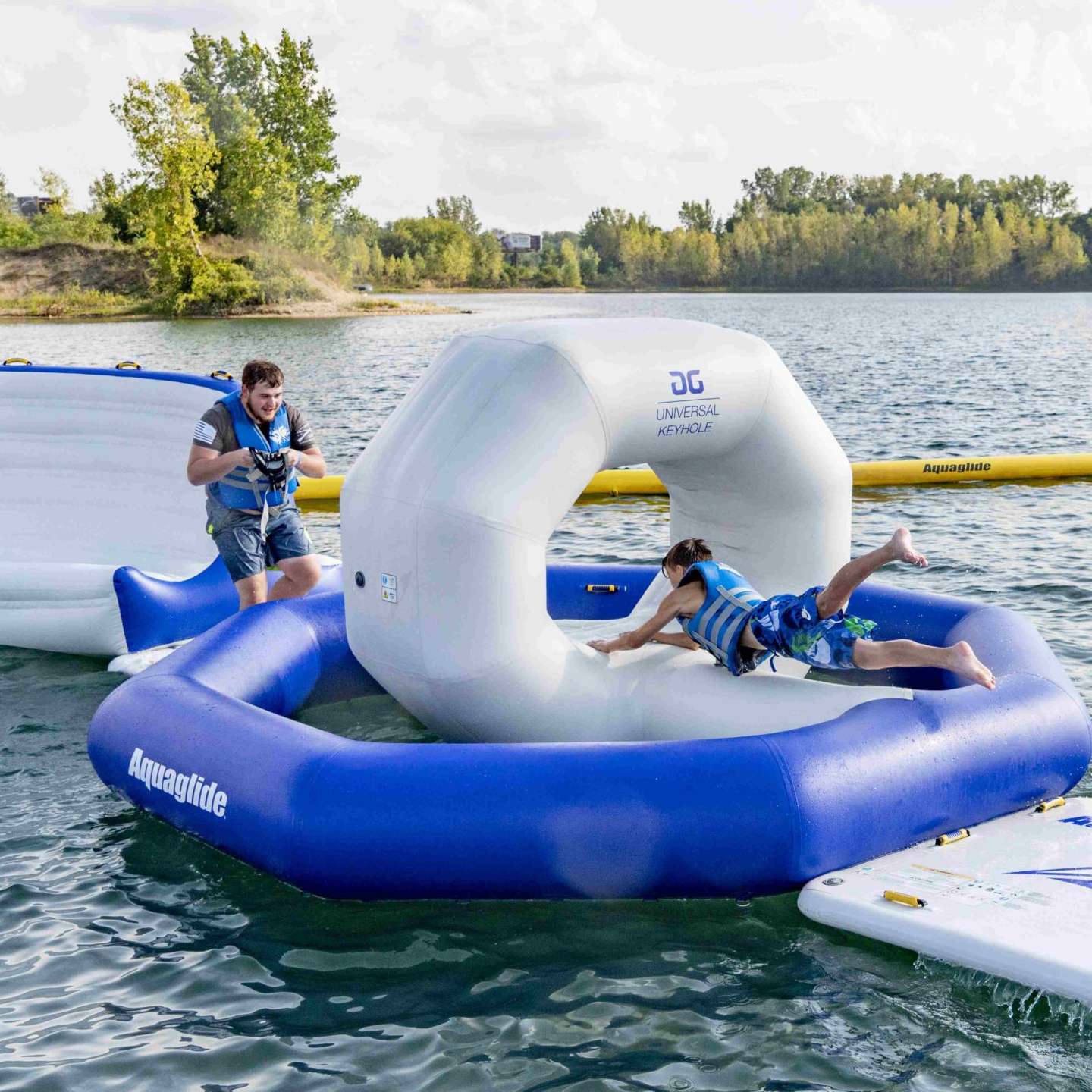 aquaglide-uni-keyhole-alt1-zoom Aquaglide Universal Keyhole inflatable aquapark module set up on the water as part of a modular floating aquapark course