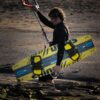 Shinn Monker Kiteboard 2025 base view showing the underside graphic, channels and rocker profile