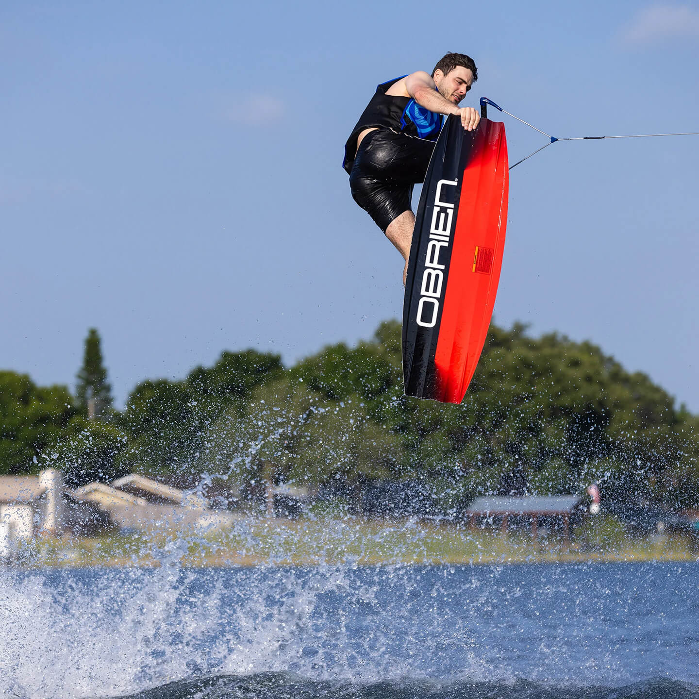 O'Brien System 2026 Wakeboard lifestyle action image showing the wakeboard on the water
