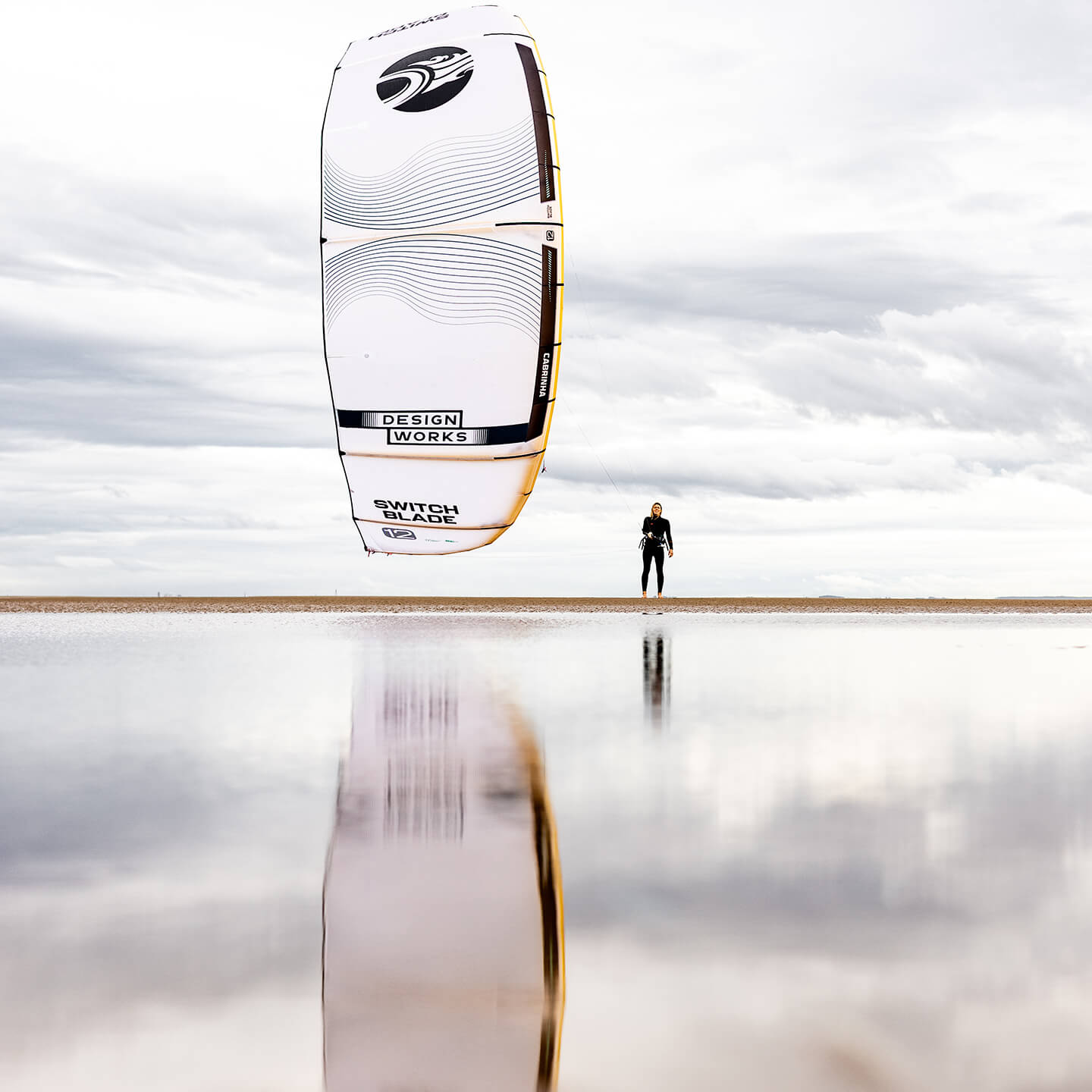 Cabrinha Switchblade Design Works 2026 Kite on beach reflecting in the wet sand