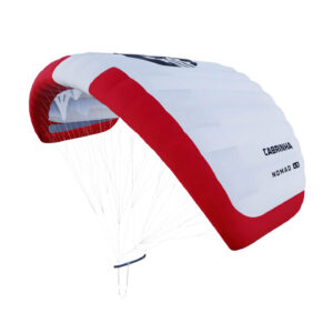 Cutout of the Cabrinha Nomad parawing in red and white, shown from a three-quarter angle with flying lines and pigtail visible against a white background.