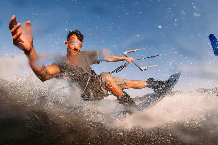 Duotone TS Park Kiteboard 2027 twin-tip kiteboard  waving to camera